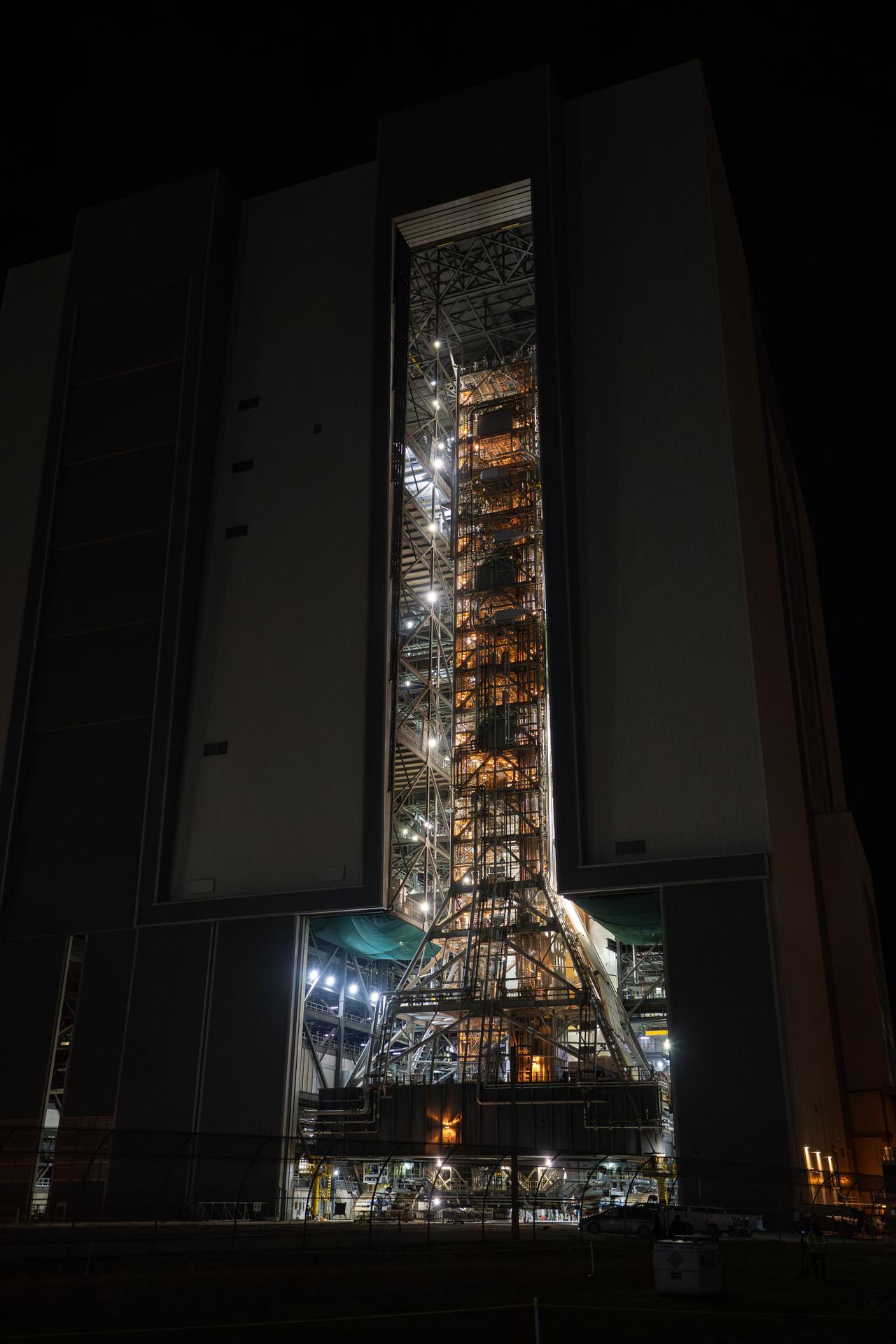 This image shows NASA’s SLS (Space Launch System) and Orion spacecraft rolling out of the Vehicle Assembly Building at NASA’s Kennedy Space Center. NASA's massive Crawler-Transporter, upgraded for the Artemis program, carries the powerful SLS rocket and Orion spacecraft on the Mobile Launcher from the Vehicle Assembly Building to Launch Pad 39B at Kennedy Space Center   in preparation for the Artemis II mission.  